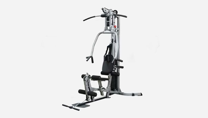 Multi-station home gym machine with lat pulldown bar, press arms, leg extension, and a weight stack on a white background.